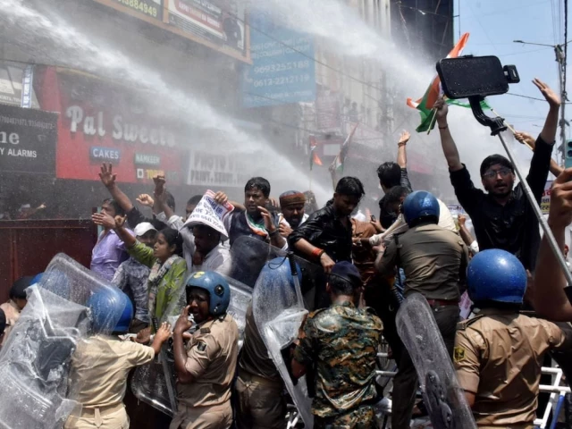 Indian police use water cannon at new protest over test paper leaks